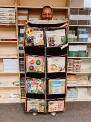 Our General Assistant holding up the packed hanging library